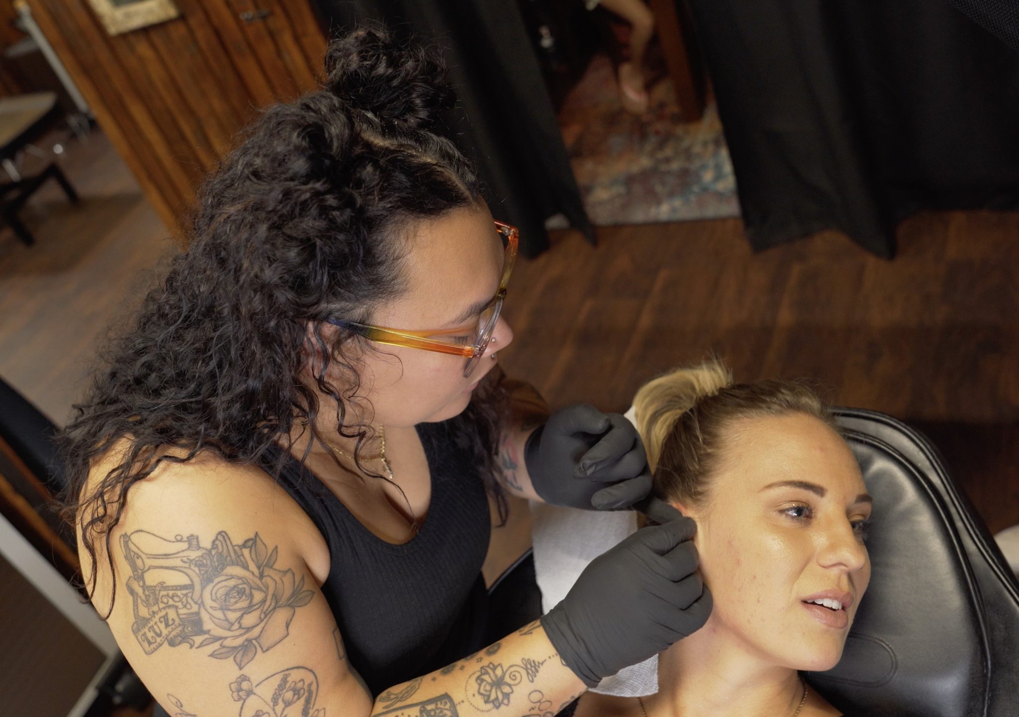 Woman getting her ear pierced